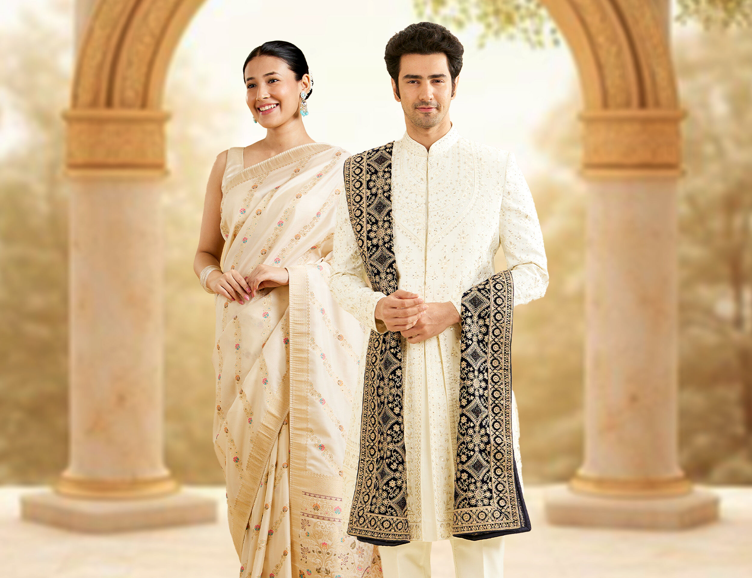 A bride in cream colour saree and groom in white sherwani 